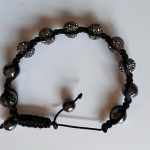 Bracelet with black cord and grey accesories